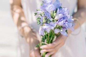 woman holding a bunch of freesia flowers